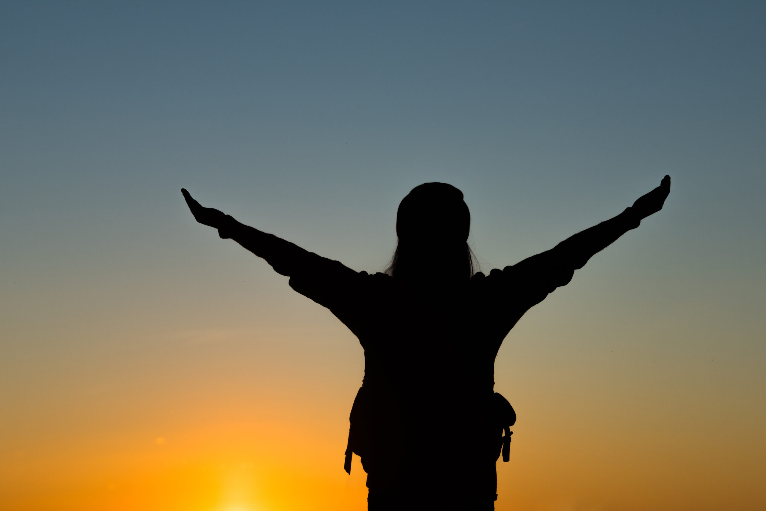 Silhouette of tourist woman standing in the mountain